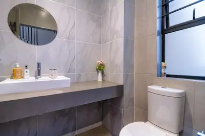 a bathroom with a toilet and a sink and a mirror at AlimamaSpacesThe Mansons Cascades Villa in Midrand