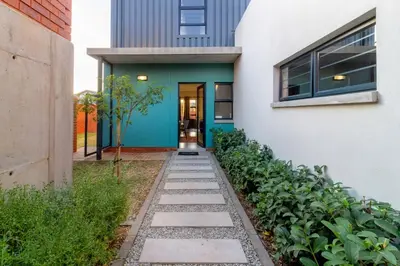 a house with a blue door and a walkway at AlimamaSpacesThe Mansons Cascades Villa in Midrand