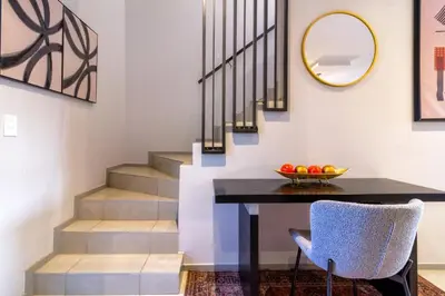 a dining room with a table and a mirror at AlimamaSpacesThe Mansons Cascades Villa in Midrand