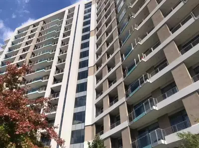 a tall apartment building with balconies on it at AlimamaSpaces The Noxy Menlyn Maine in Pretoria