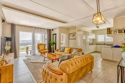 a living room with two couches and a kitchen at AlimamaSpaces Semandi Polofields in Midrand