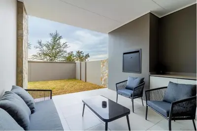 a living room with a couch and chairs and a tv at AlimamaSpaces Josephs Polofields in Midrand
