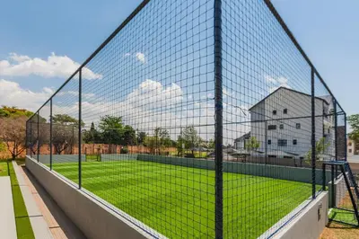 a tennis court with a net on a court at AlimamaSpaces Panos Whisken in Midrand