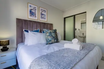 a bedroom with a bed with a towel on it at AlimamaSpaces Phillys Whisken in Midrand