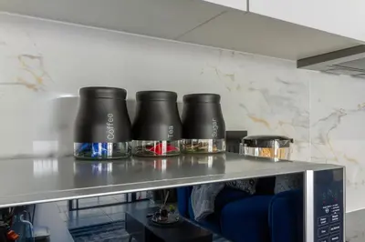 a counter with three black pots on a shelf at AlimamaSpaces Phillys Whisken in Midrand