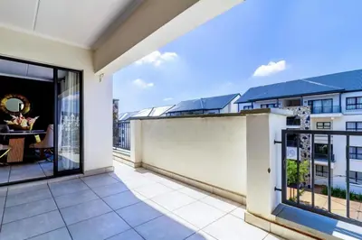 a balcony with a view of a building at AlimamaSpaces Farais Whisken Apartment in Midrand