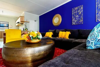 a living room with a couch and a table at AlimamaSpaces Farais Whisken Apartment in Midrand