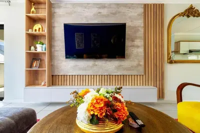 a vase of flowers on a table in a living room at AlimamaSpaces Farais Whisken Apartment in Midrand