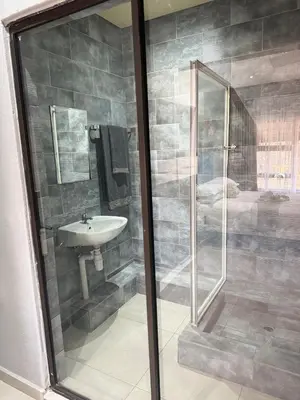 a bathroom with a shower and a sink at Glowti Event & Guest House in Centurion