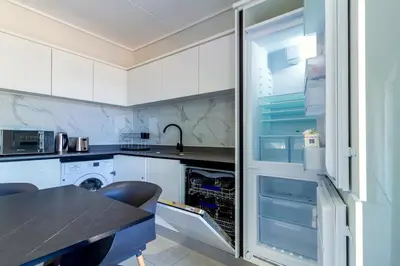a kitchen with a refrigerator with its door open at #AlimamaSpaces Jay's Polofields in Midrand