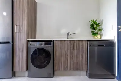 a kitchen with a washing machine and a sink at #AlimamaSpaces The Manson's Kyalami Woods in Midrand