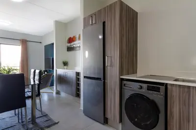 a kitchen with a washer and a dishwasher at #AlimamaSpaces The Manson's Kyalami Woods in Midrand