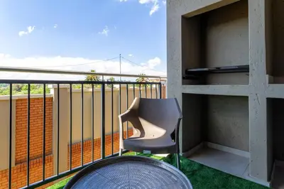 a chair sitting on a balcony with a view at #AlimamaSpaces The Manson's Kyalami Woods in Midrand