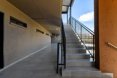 an empty hallway of a building with stairs at #AlimamaSpaces The Rob's Kyalami Woods in Midrand