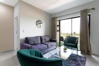 a living room with a purple couch and chairs at #AlimamaSpaces The Chelsea Kyalami Woods in Midrand