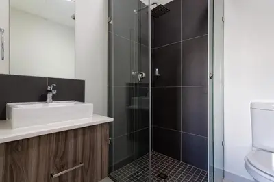a bathroom with a sink and a shower at #AlimamaSpaces The Bob's Kyalami Woods in Midrand