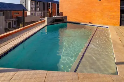 a swimming pool on top of a building at #AlimamaSpaces Thando's Waterfalls Villa in Midrand