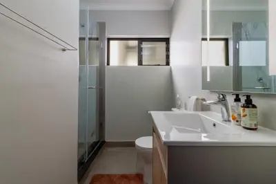 a bathroom with a toilet and a sink and a shower at #AlimamaSpaces The Manson Umthunzi View in Vosburg