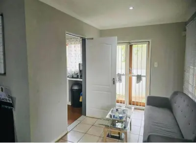 a living room with a couch and a table at The Chardonnay Inn in Centurion