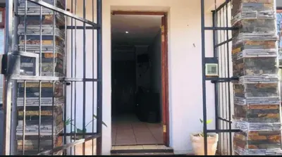 a door with a iron gate leading to a hallway at The Chardonnay Inn in Centurion