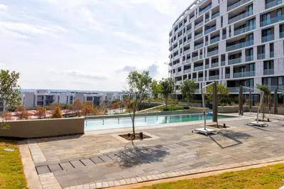 a large building with a courtyard with a swimming pool at #AlimamaSpaces The Chelsea's Cassini Ellipse in Vosburg