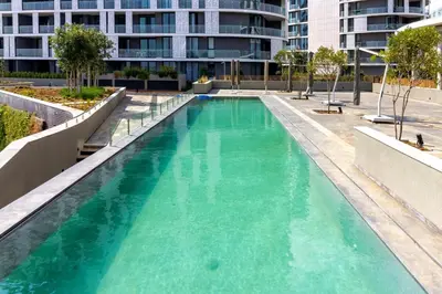 a swimming pool with green water in a building at #AlimamaSpaces The Chelsea's Cassini Ellipse in Vosburg