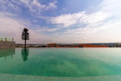 a large swimming pool with a tree in the middle at #AlimamaSpaces The Chelsea's Cassini Ellipse in Vosburg