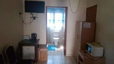 a bathroom with a toilet and a television in a room at C'est Si Bon Accommodation at 03 Beitel, Mokopane in Mokopane
