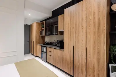 a kitchen with wooden cabinets and a counter top at Modern & Peaceful Studio in Pretoria