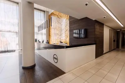 a lobby with a reception desk in a building at Modern & Peaceful Studio in Pretoria