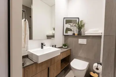 a bathroom with a white sink and a toilet at Modern & Peaceful Studio in Pretoria