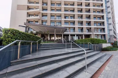 a building with stairs in front of a building at Modern & Peaceful Studio in Pretoria