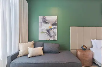 a living room with a couch and a painting at Capital City Luxury Apartment 830 Menlyn Maine in Pretoria