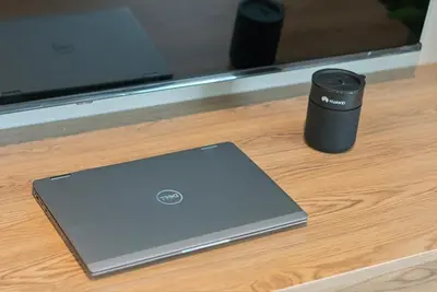 a laptop computer sitting on a table with a cup at Capital City Luxury Apartment 830 Menlyn Maine in Pretoria