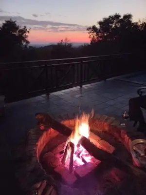 a fire pit with a person sitting around it at Mafuta Lodge - Mabalingwe Nature Reserve in Warmbaths