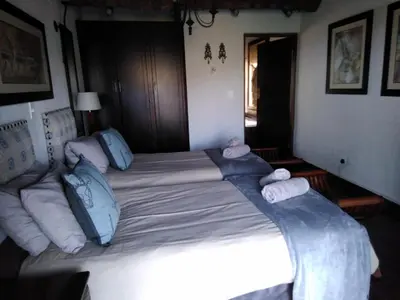 a large bed in a bedroom with towels on it at Mafuta Lodge - Mabalingwe Nature Reserve in Warmbaths