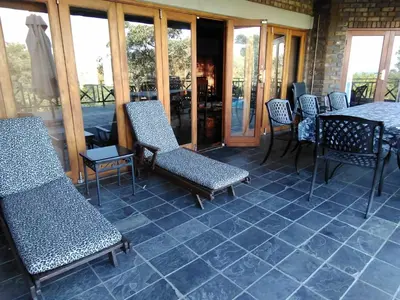 a patio with chairs and a table on a patio at Mafuta Lodge - Mabalingwe Nature Reserve in Warmbaths