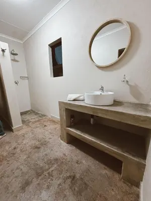 a bathroom with a sink and a mirror on the wall at Rooikrans Guest House Mpumalanga in Boschfontein
