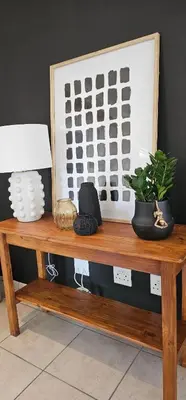 a wooden table with a plant on top of it at Rupping Bush Retreats in Mmukubyane