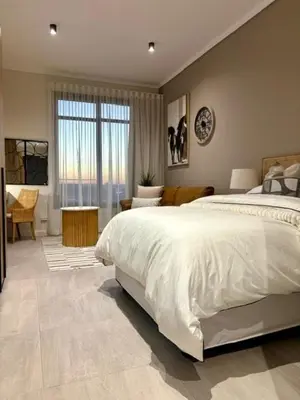 a bedroom with a large bed and a large window at Modern Studio in Menlyn Maine in Pretoria