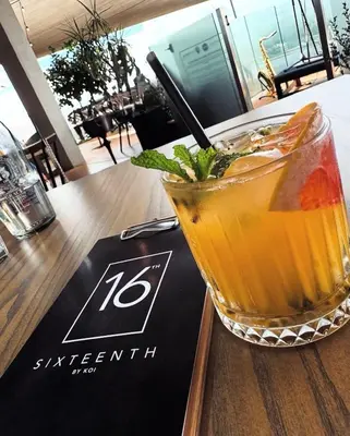 a drink sitting on top of a table at Modern Studio in Menlyn Maine in Pretoria