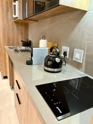 a kitchen with a tea kettle on a counter at Modern Studio in Menlyn Maine in Pretoria