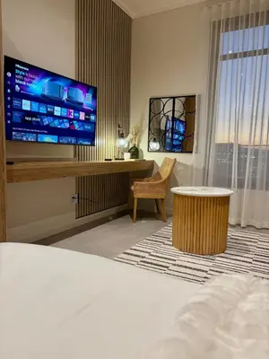 a hotel room with a bed and a flat screen tv at Modern Studio in Menlyn Maine in Pretoria