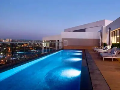 a swimming pool on top of a building with a city skyline at Modern Studio in Menlyn Maine in Pretoria