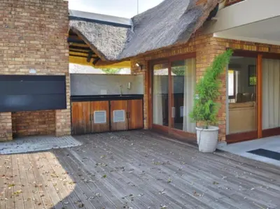 a brick house with a large patio with a potted plant at Kruger Park Lodge Unit 268 & Unit 531 in Hazyview