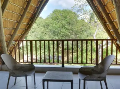 two chairs and a table in front of a window at Kruger Park Lodge Unit 268 & Unit 531 in Hazyview