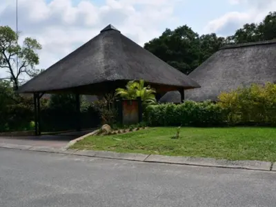 a hut with a thatched roof on the side of a road at Kruger Park Lodge Unit 268 & Unit 531 in Hazyview