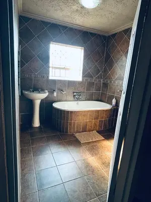 a bathroom with a tub and a sink at Kioma guest house mahwelereng in Mokopane