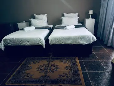 two beds sitting next to each other in a room at Kioma guest house mahwelereng in Mokopane
