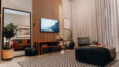 a living room with a bed and a mirror at Urban Gem on 18th Prime Location in Pretoria